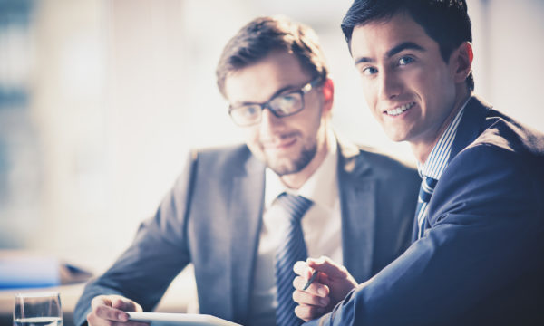 Businessmen at meeting Image of smart young businessmen looking at camera at meeting